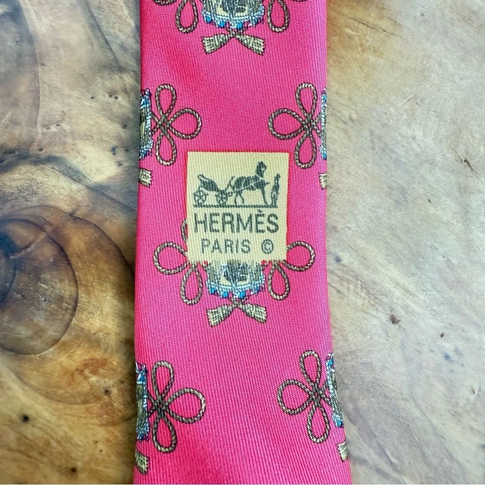 Vintage Hermès red silk tie with a repeating drum motif 3.5” x 54”